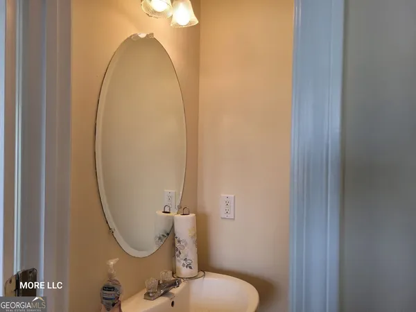 a bathroom with a sink mirror and toilet
