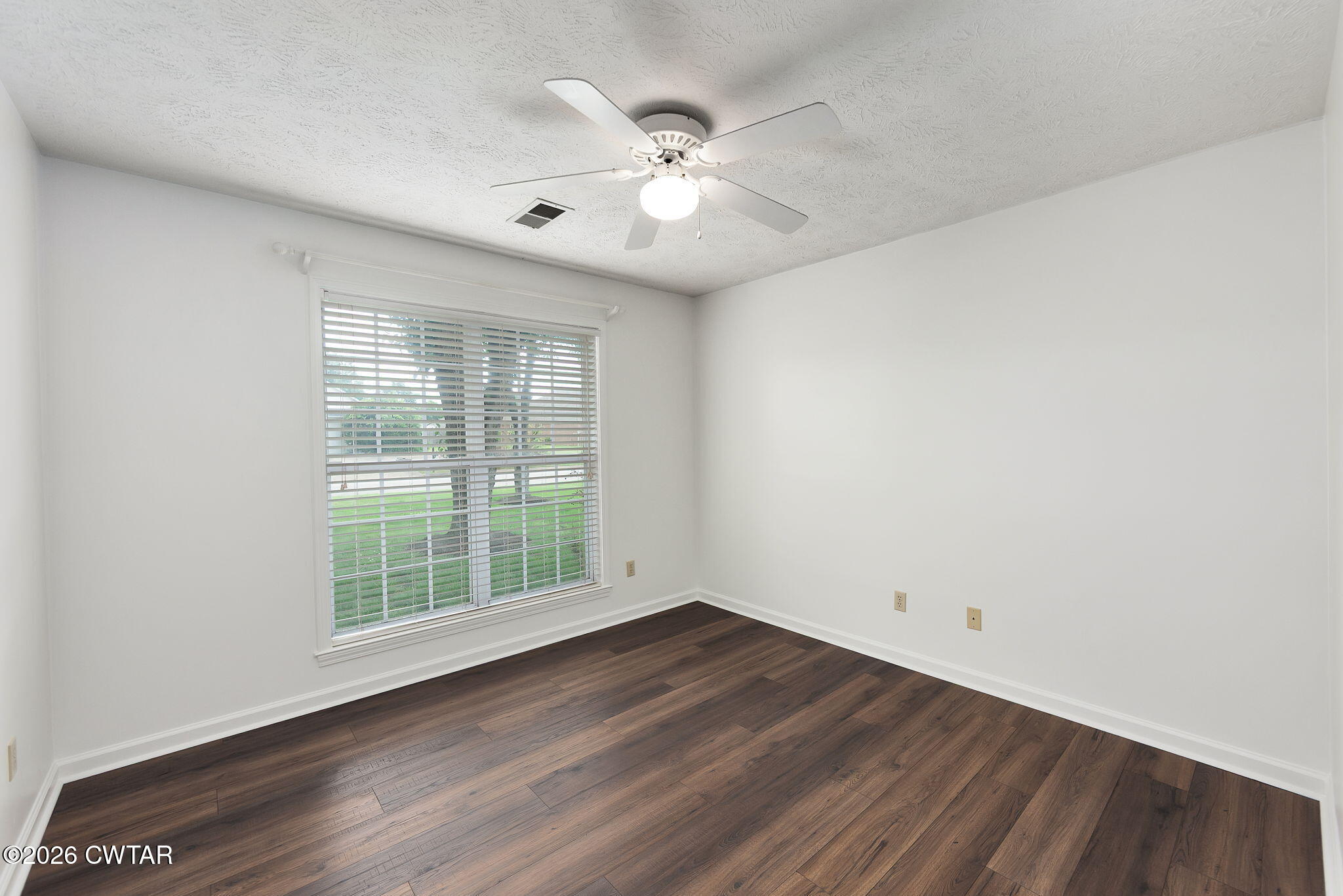96 Sundown Drive Jackson, TN 38305 - Photo 18 of 28 wooden floor in an empty room with a window