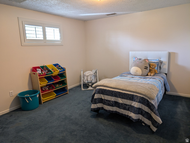 1411 Millbrook Way Bountiful, UT 84010 - Photo 27 of 36 Bedroom with neutral wall paint with baseboard trim and blue carpeting