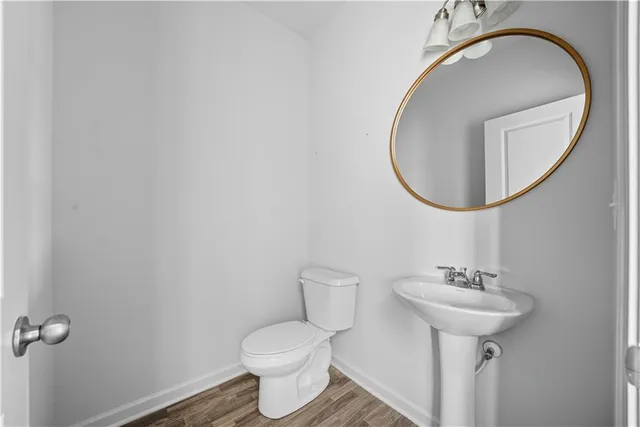 a view of a hallway with wooden floor and entryway