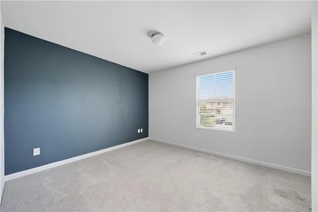 a view of an empty room with a closet