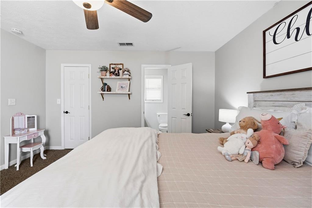 2777 Chickadee Drive Monroe, GA 30655 - Photo 29 of 36 a bedroom with a bed and a walk in closet