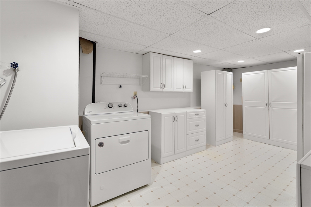 4 Jeffrey Road Canton, MA 02021 - Photo 18 of 26 a utility room with cabinets washer and dryer