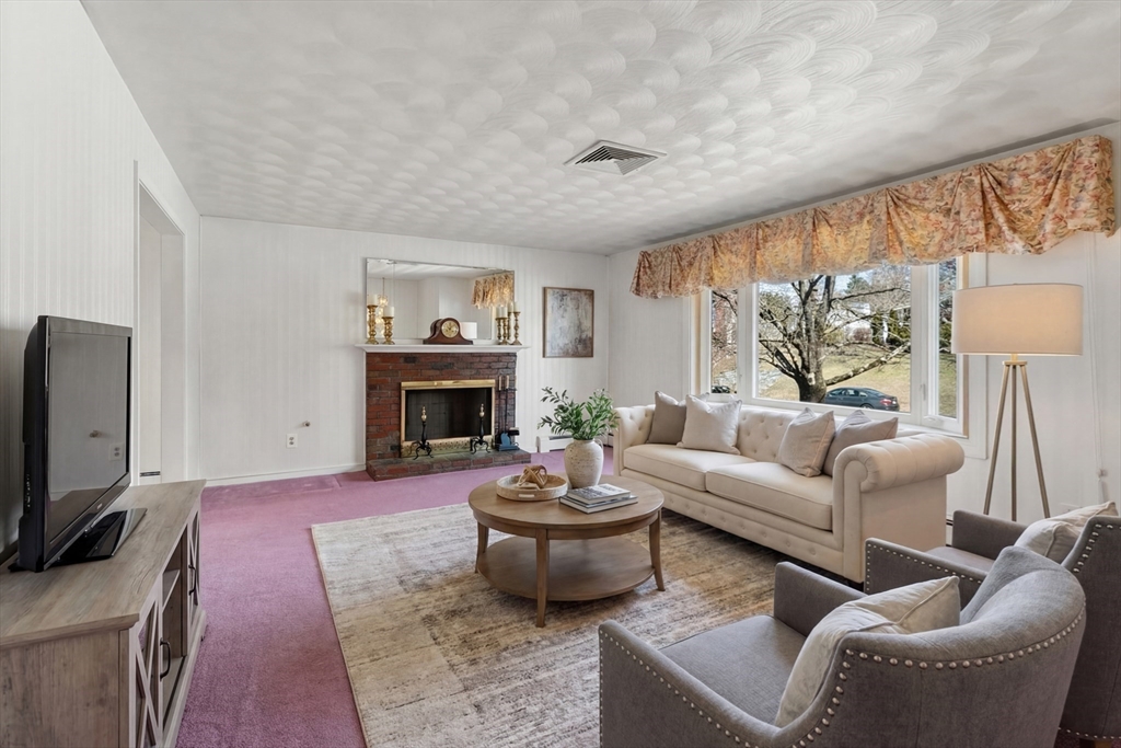 4 Jeffrey Road Canton, MA 02021 - Photo 4 of 26 a living room with furniture a fireplace and a flat screen tv