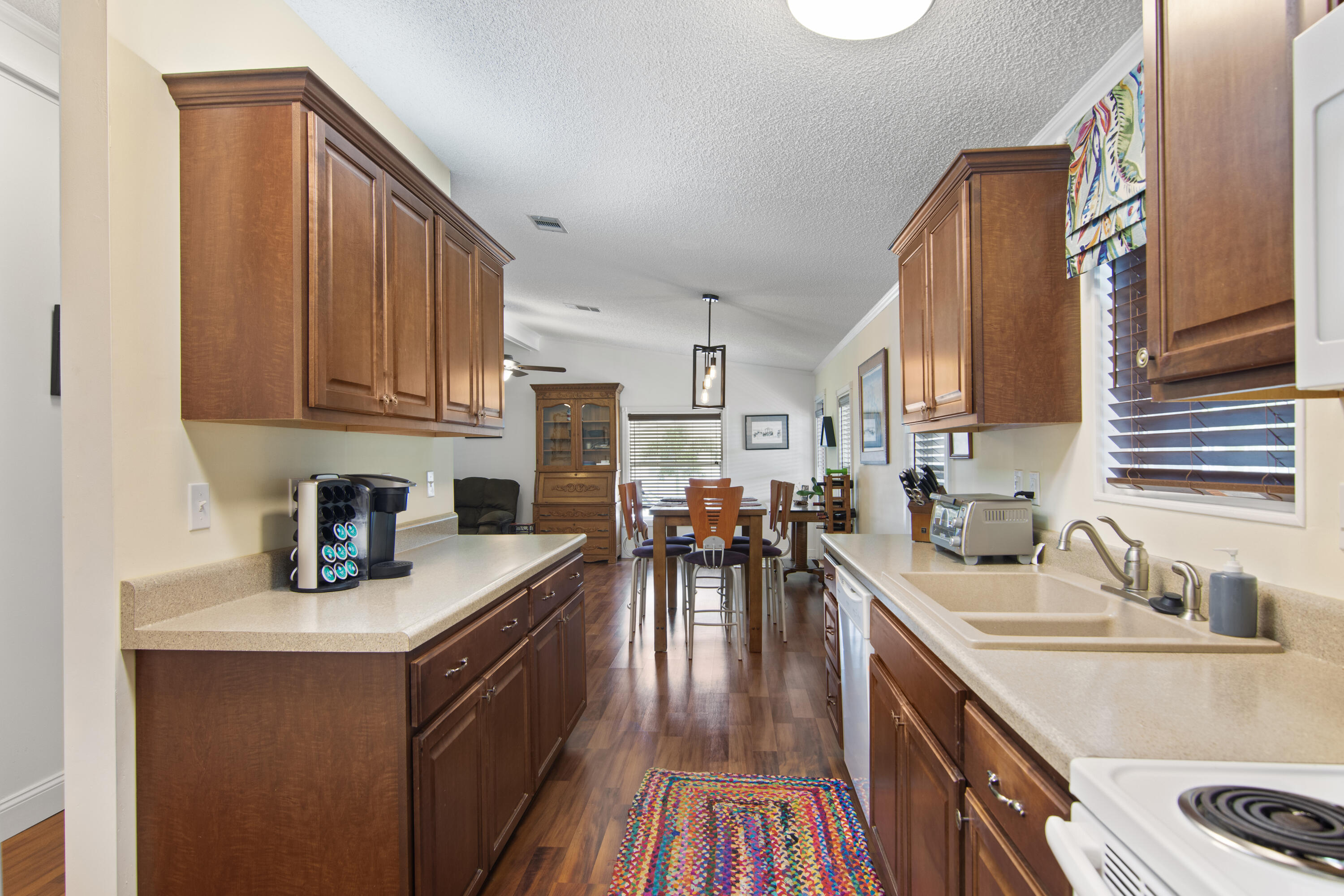 223 Sea Conch Place, Unit 14 Fort Pierce, FL 34982 - Photo 15 of 28 a kitchen with a sink stove and cabinets
