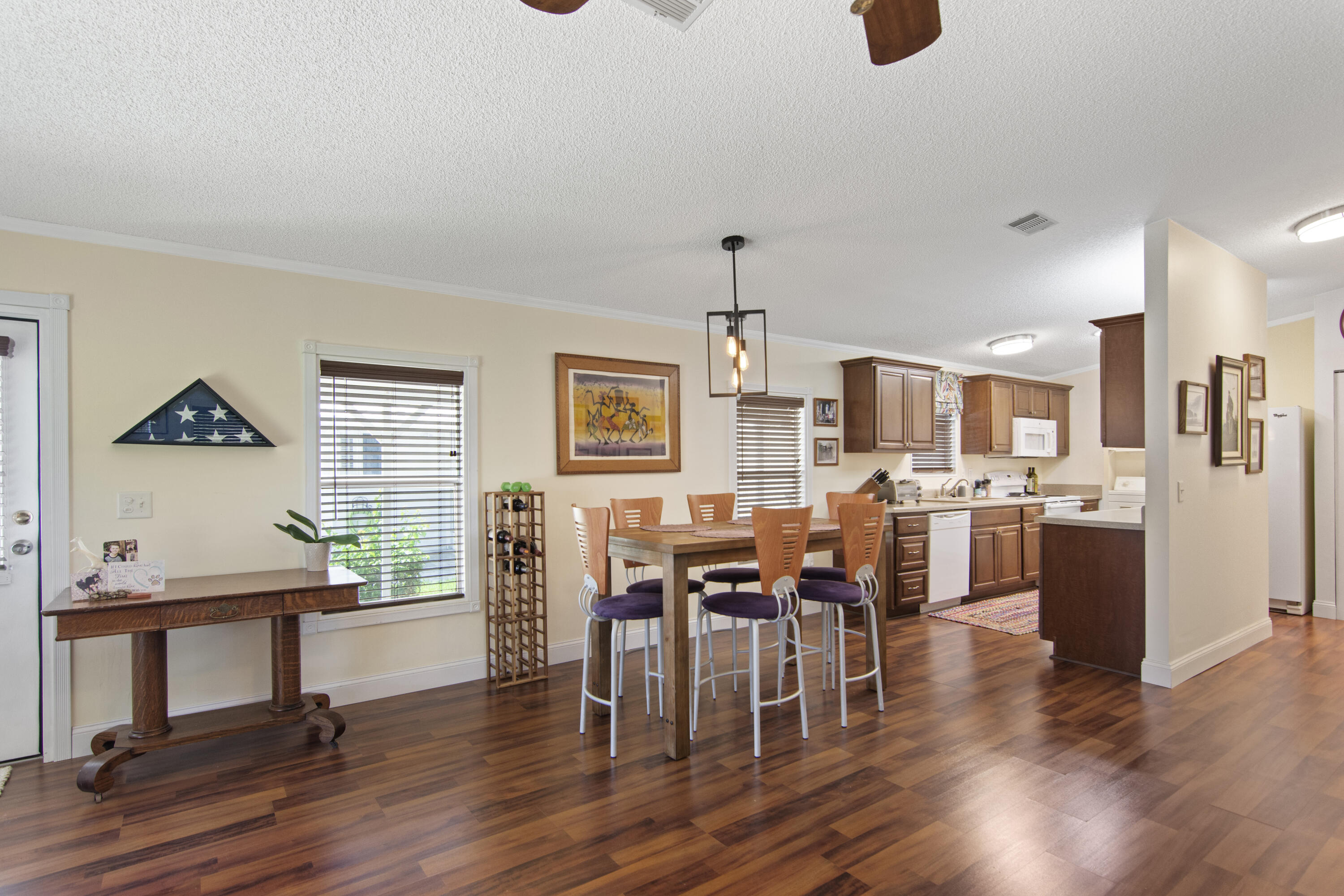 223 Sea Conch Place, Unit 14 Fort Pierce, FL 34982 - Photo 19 of 28 a view of a dining room with furniture and wooden floor