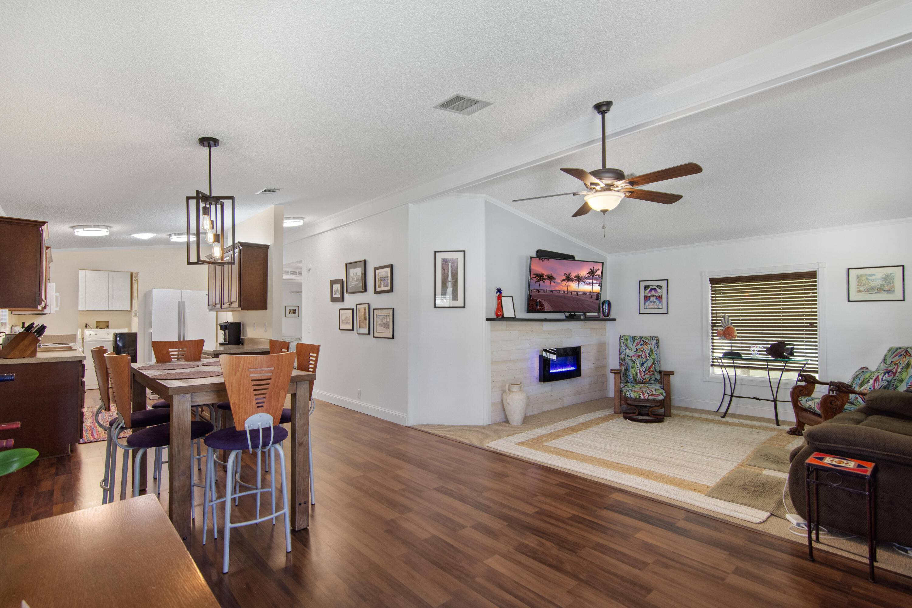 223 Sea Conch Place, Unit 14 Fort Pierce, FL 34982 - Photo 20 of 28 a living room with furniture a dining table and a chandelier