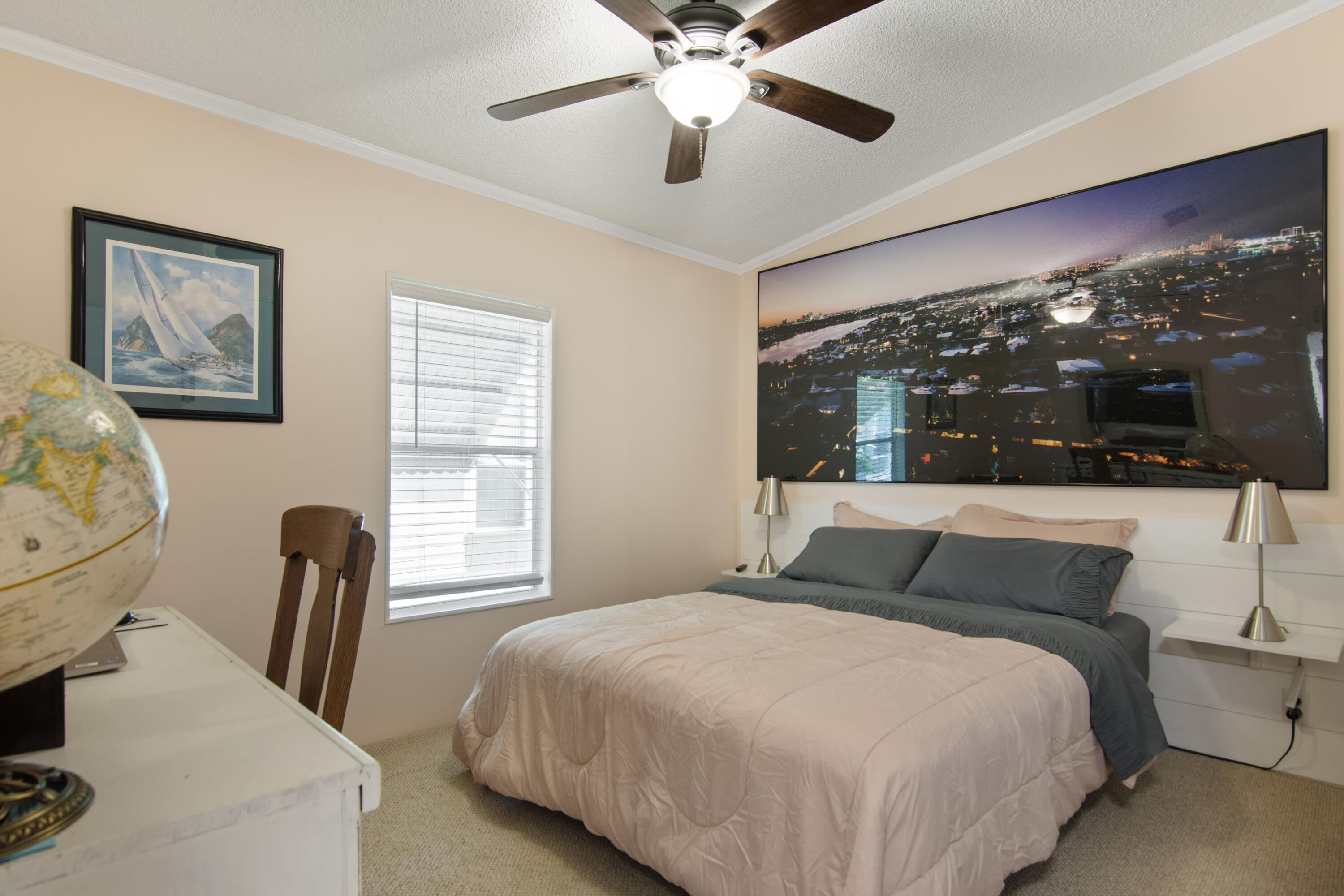 223 Sea Conch Place, Unit 14 Fort Pierce, FL 34982 - Photo 24 of 28 a bedroom with a bed and glass window