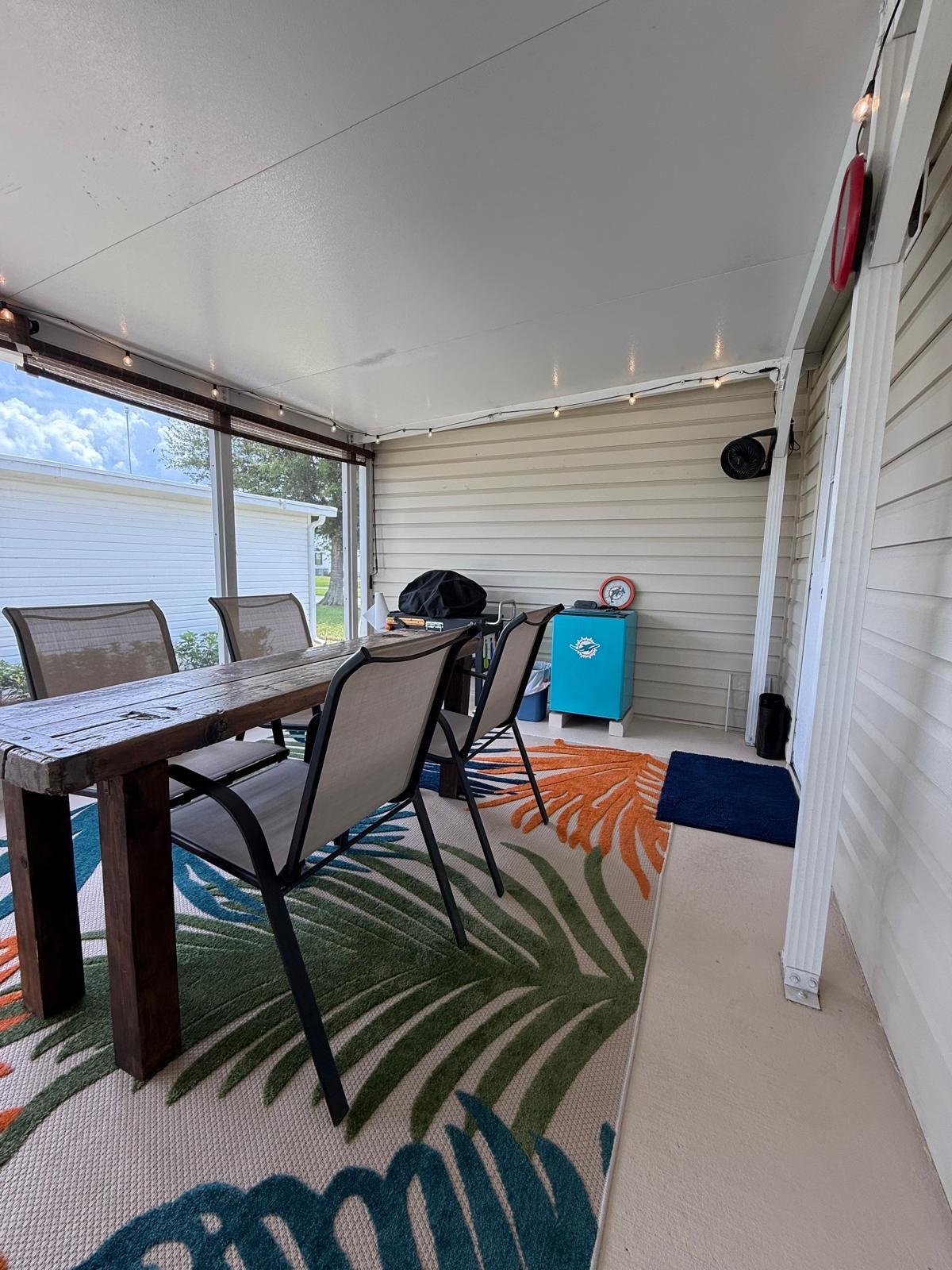 223 Sea Conch Place, Unit 14 Fort Pierce, FL 34982 - Photo 10 of 28 a bedroom with a bed and wooden floor