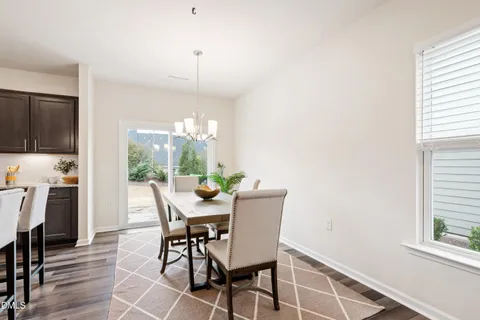 a living room with furniture kitchen view and a table