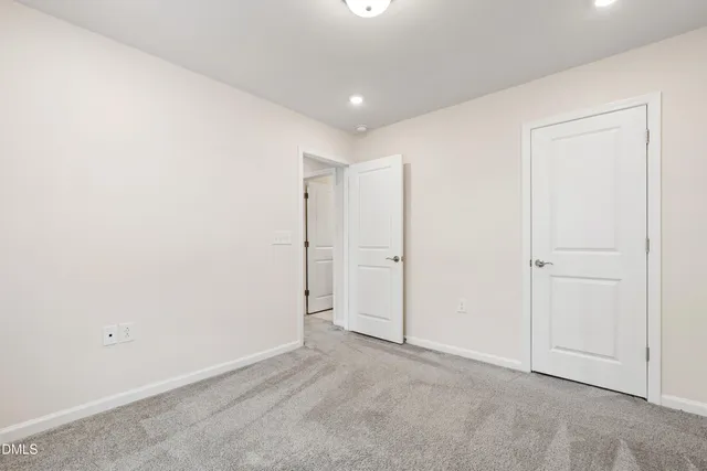 an empty room with windows and furniture