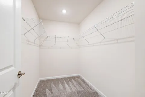 a bedroom with a large bed and painting on the wall