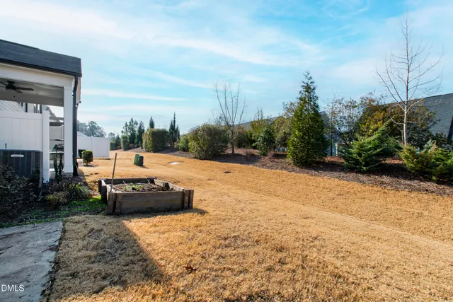 a view of a house with a yard and sitting area