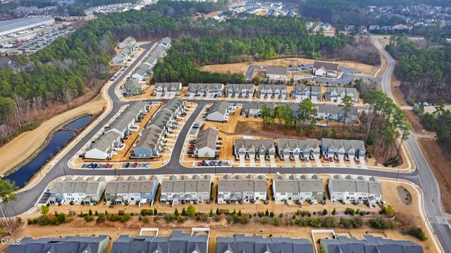 an aerial view of residential building and lake