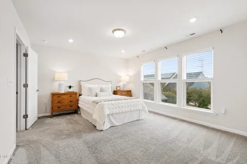 a kitchen with stainless steel appliances kitchen island granite countertop a stove a sink a refrigerator and chairs