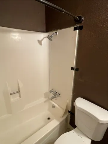 a bathroom with a toilet and a bathtub