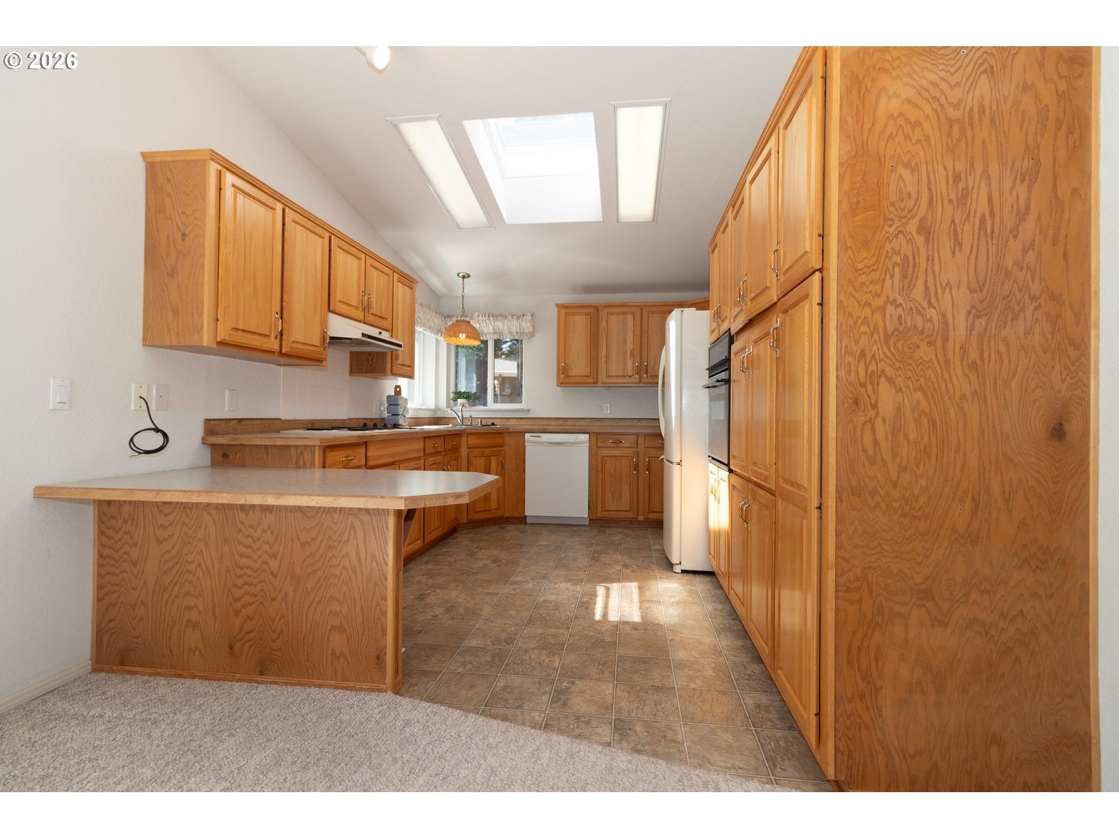 499 Sherwood Loop Florence, OR 97439 - Photo 17 of 39 a kitchen with stainless steel appliances granite countertop a refrigerator a stove and a sink