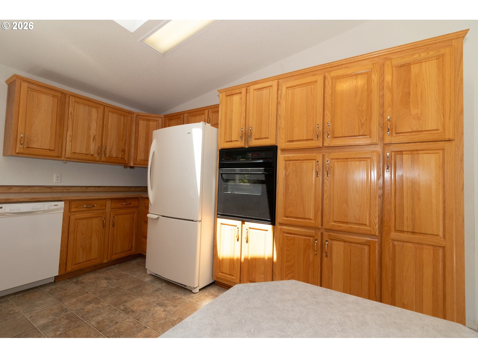 499 Sherwood Loop Florence, OR 97439 - Photo 18 of 39 a kitchen with a refrigerator and cabinets
