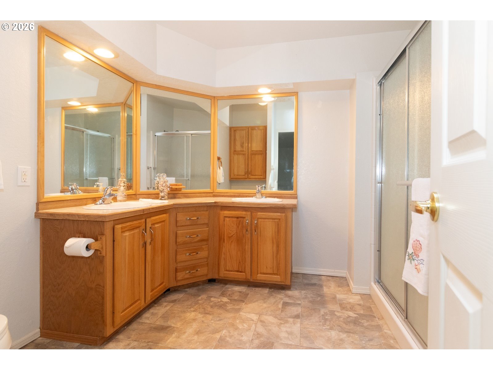 499 Sherwood Loop Florence, OR 97439 - Photo 26 of 39 a bathroom with a sink a mirror and a shower