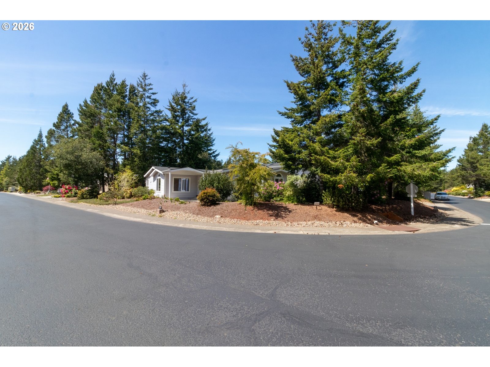 499 Sherwood Loop Florence, OR 97439 - Photo 3 of 39 a picture of a road with a building in the background