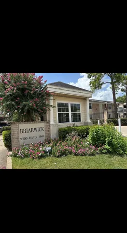 a view of front a house with a black gate