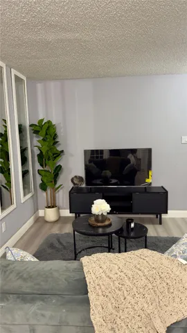 a kitchen with a stove a microwave and cabinets