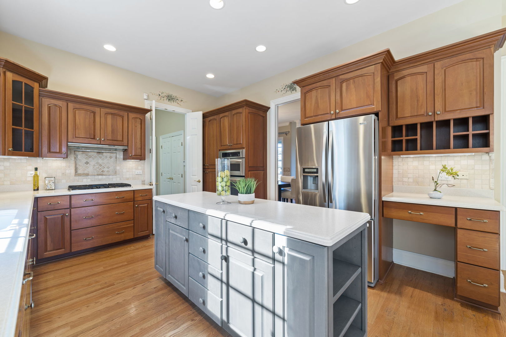 9 Forest Gate Circle Oak Brook, IL 60523 - Photo 18 of 39 a kitchen with stainless steel appliances kitchen island granite countertop a refrigerator and a stove top oven