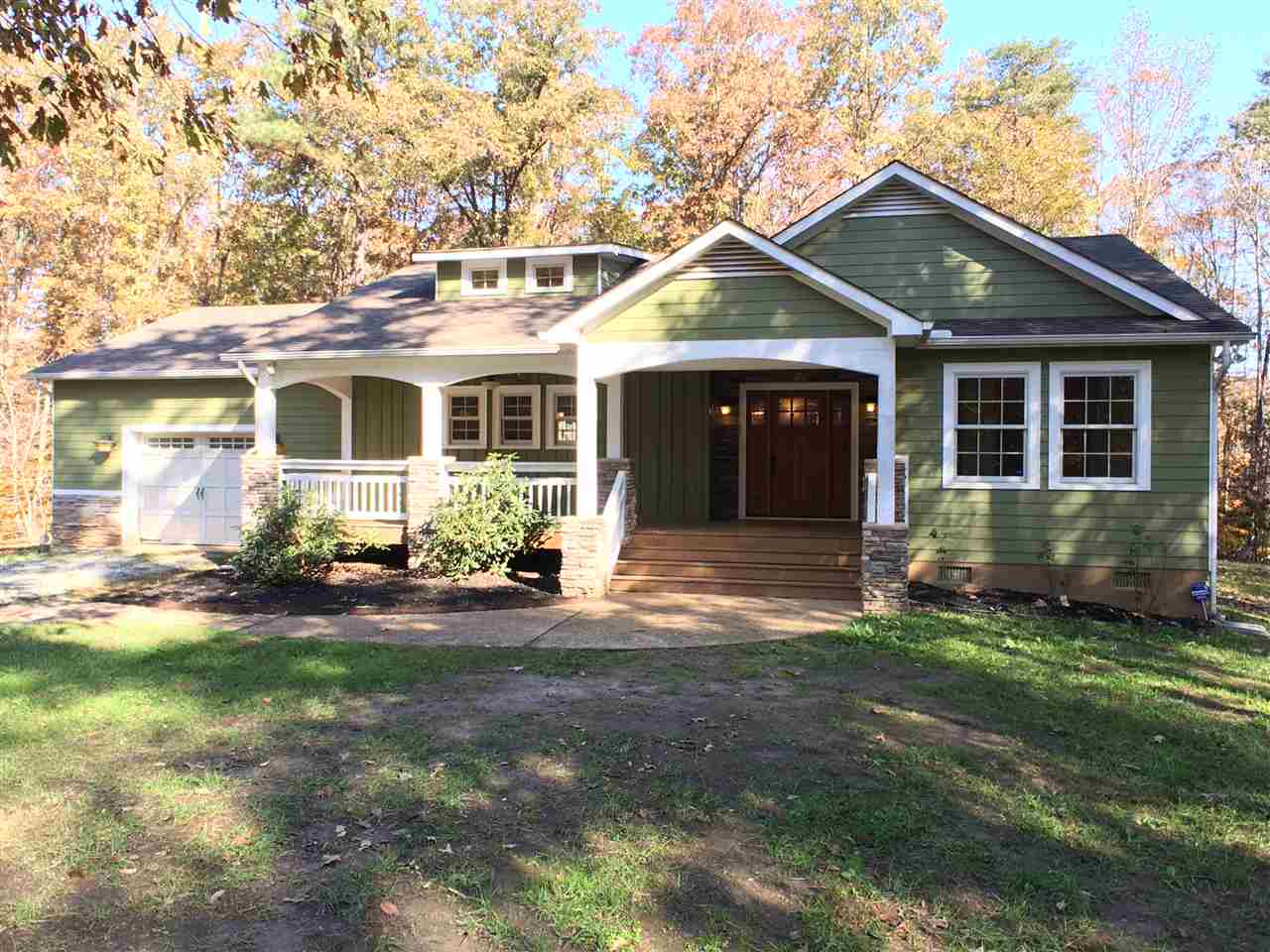 a front view of a house with a garden and yard