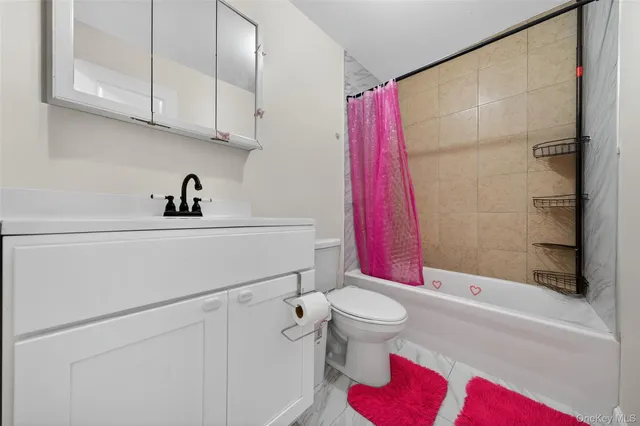 a bathroom with a sink a toilet and a shower