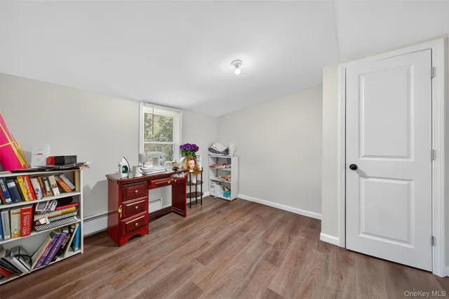 a view of a workspace with furniture and wooden floor