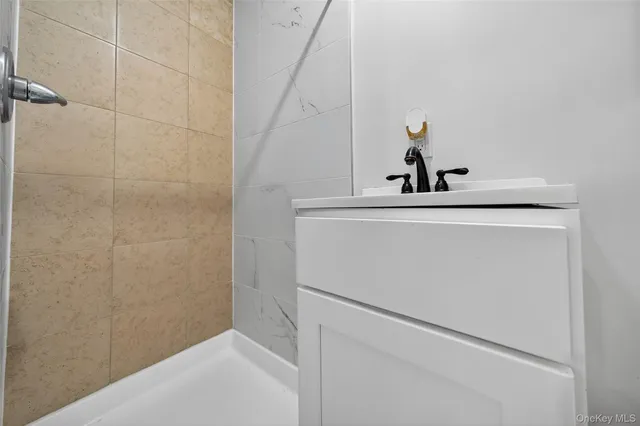 a view of washer and dryer with bathroom in the background