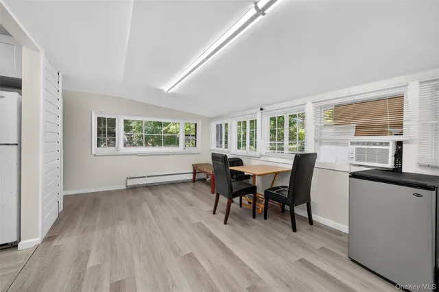 a view of a dining room with furniture window and wooden floor
