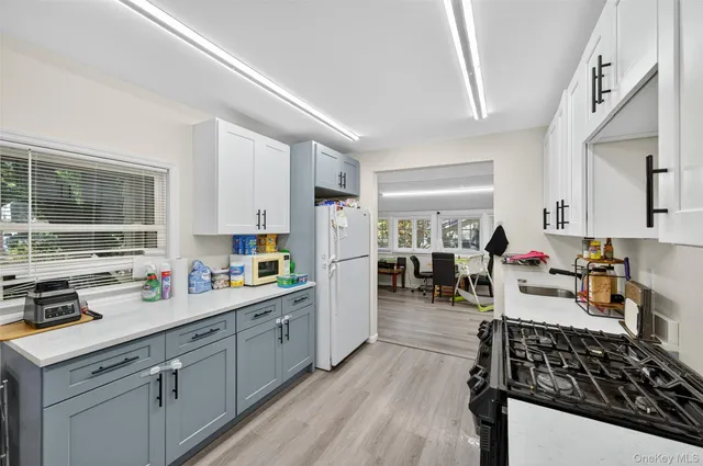 a kitchen with a sink stove and cabinets