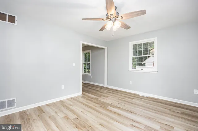 wooden floor in an empty room with a window