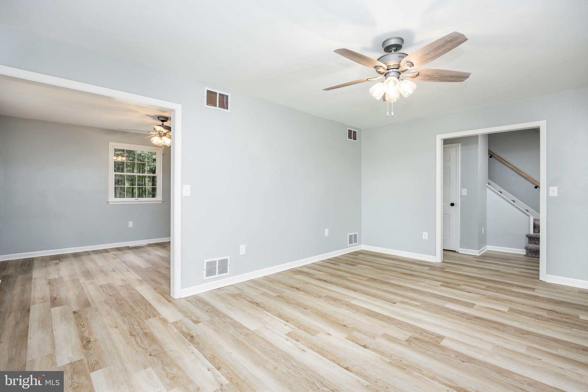 31939 Downing Road Delmar, MD 21875 - Photo 16 of 45 a view of an empty room with wooden floor and a chandelier fan