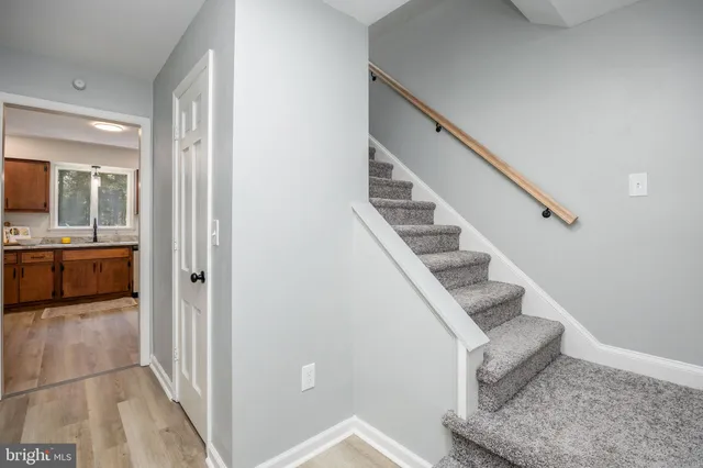 a view of entryway and hall with wooden floor