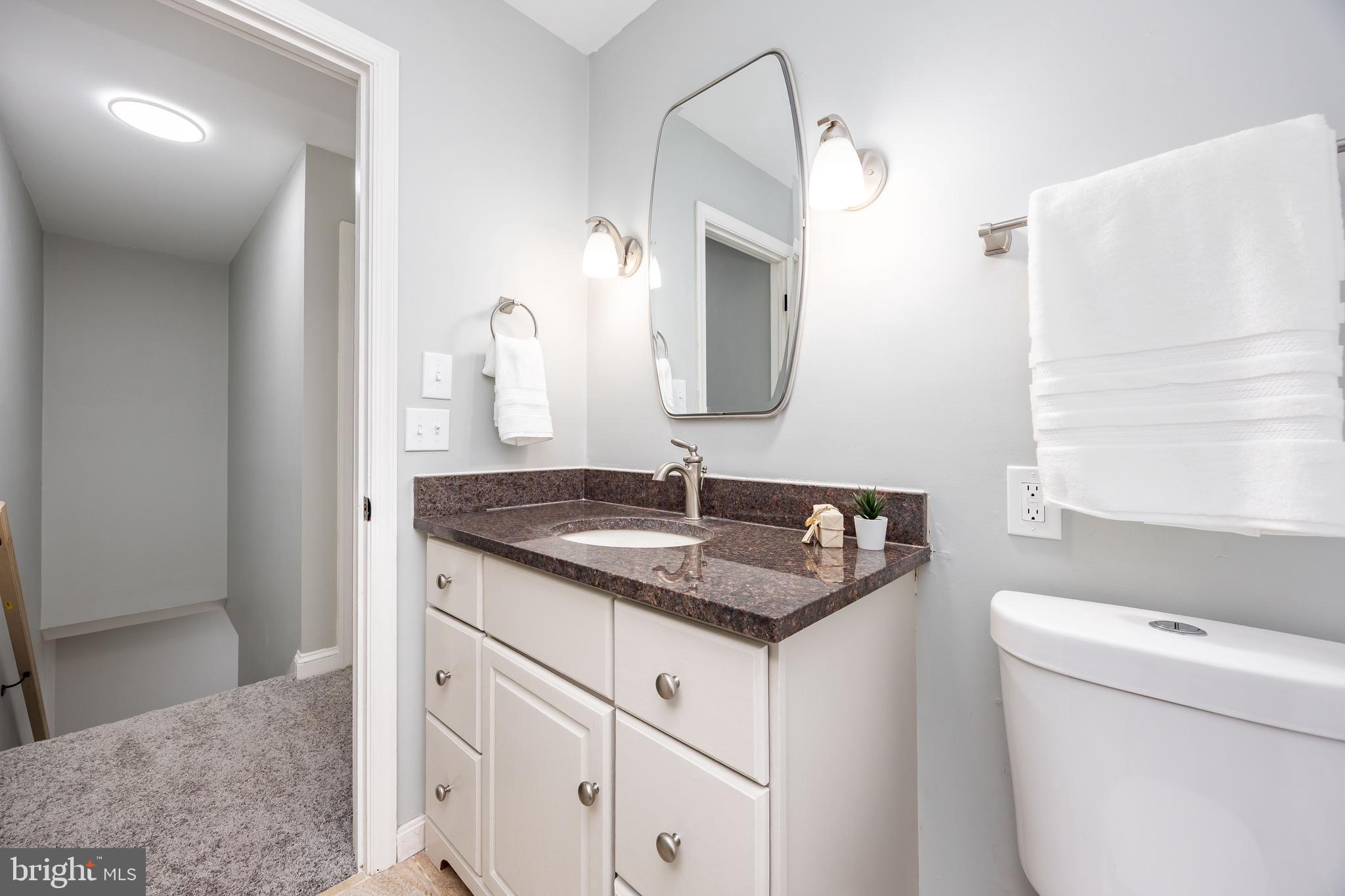 31939 Downing Road Delmar, MD 21875 - Photo 22 of 45 a bathroom with a granite countertop sink and a mirror