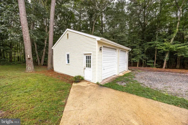 a view of backyard of house and trees