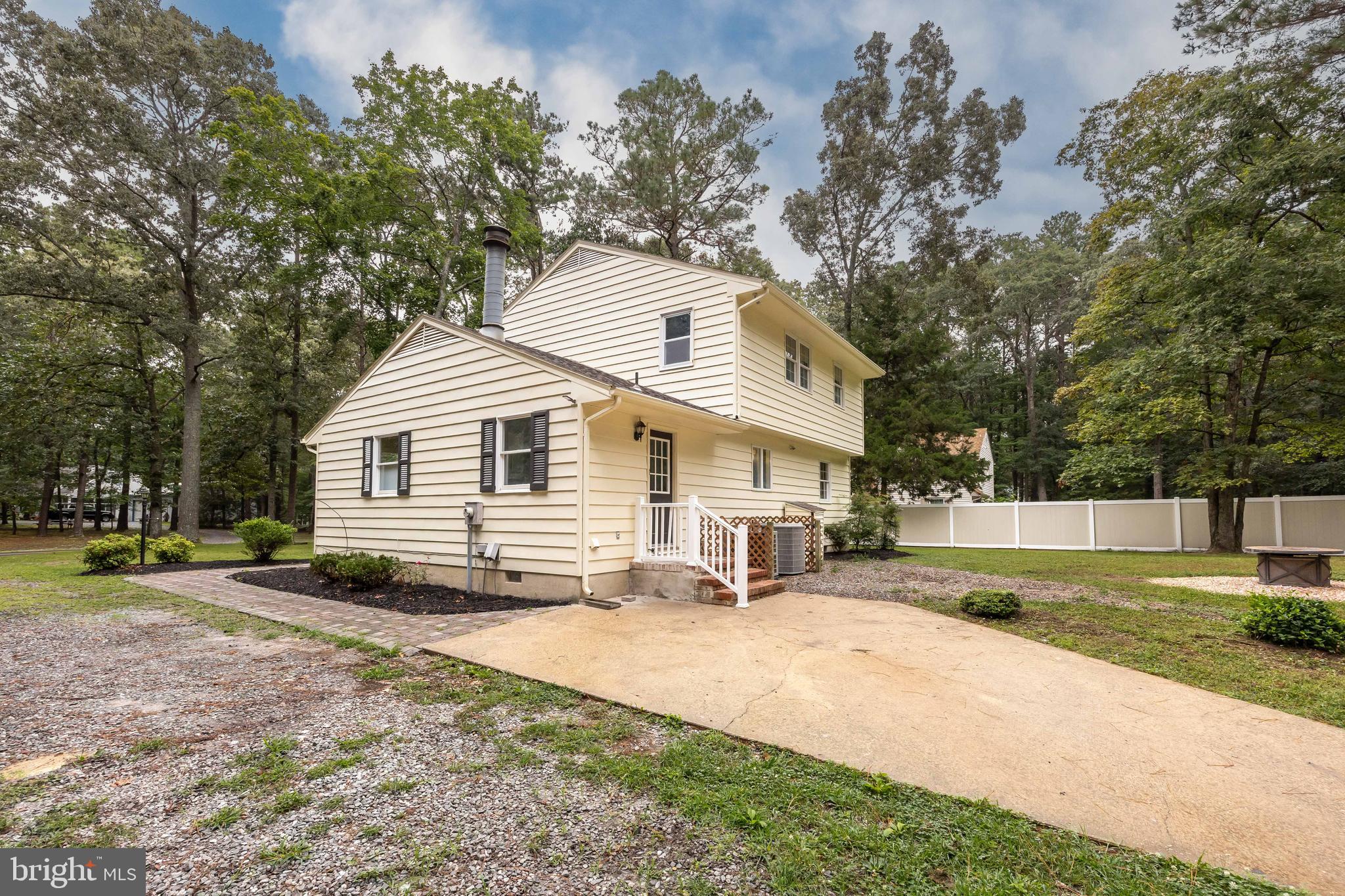 31939 Downing Road Delmar, MD 21875 - Photo 34 of 45 a view of a white house with a yard and sitting area