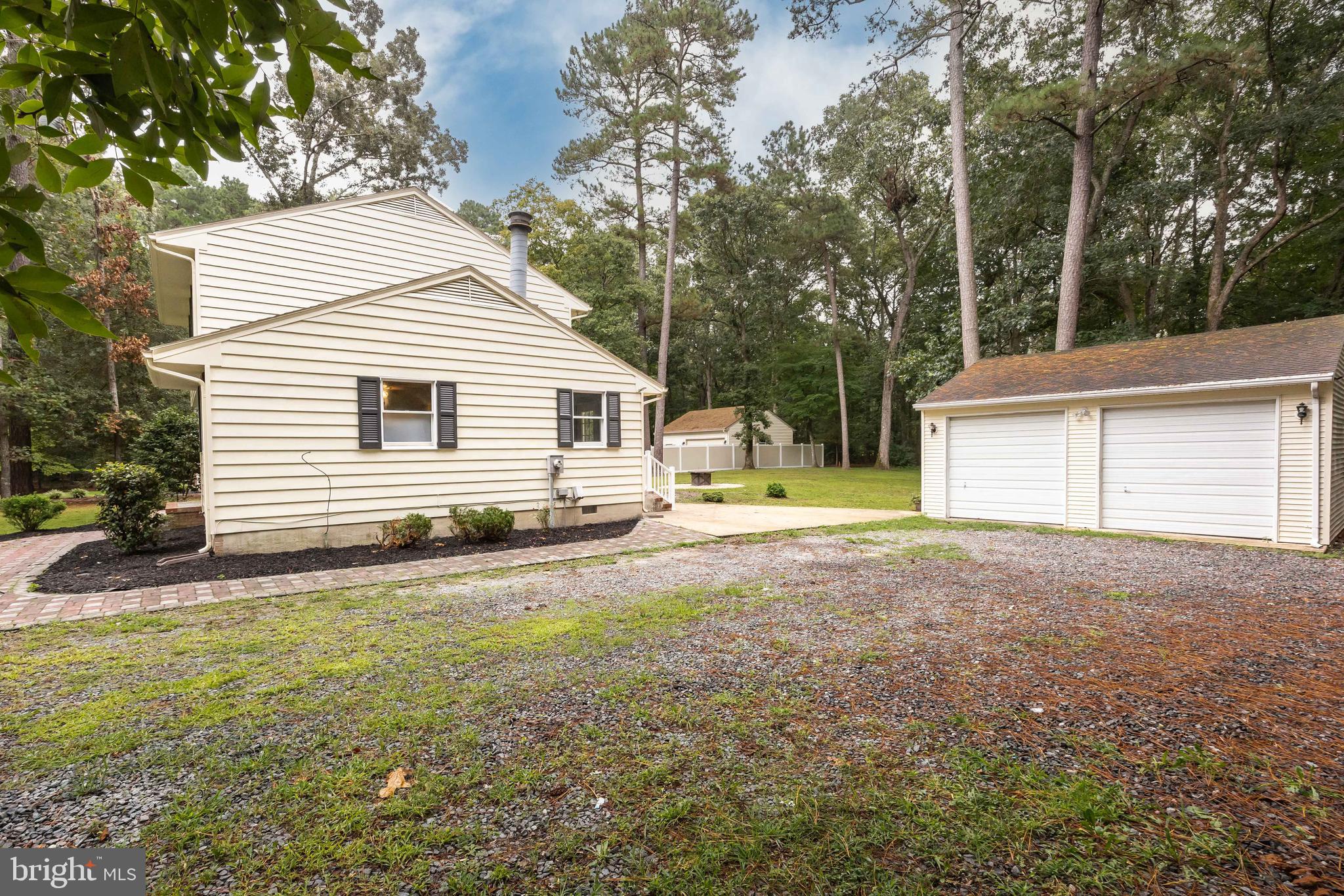 31939 Downing Road Delmar, MD 21875 - Photo 35 of 45 a backyard of a house with table and chairs
