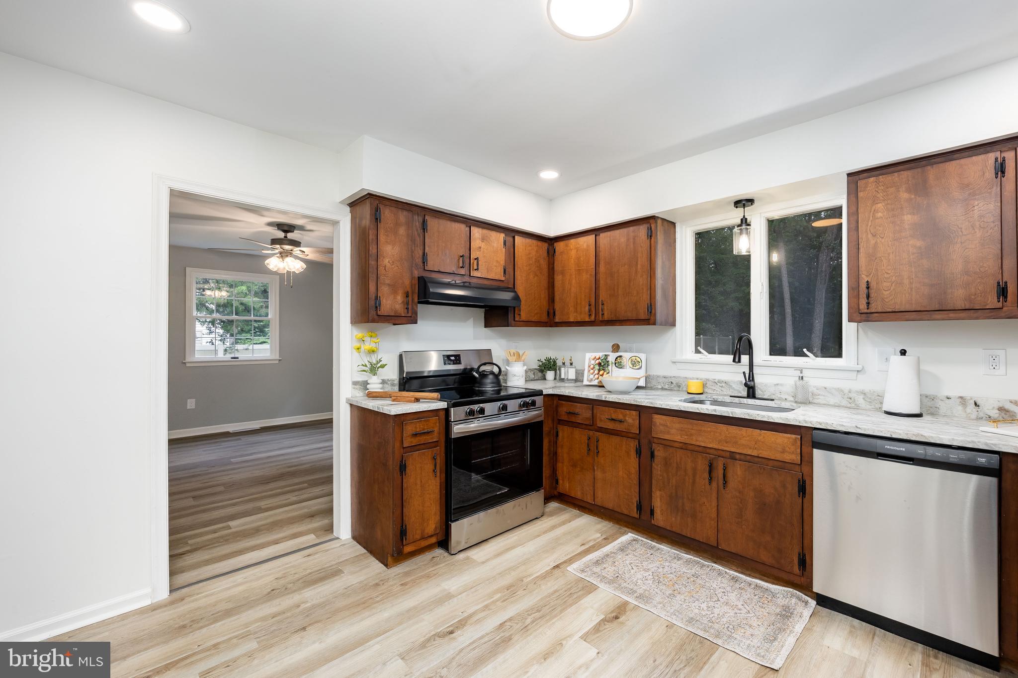 31939 Downing Road Delmar, MD 21875 - Photo 5 of 45 a kitchen with stainless steel appliances granite countertop a sink stove and refrigerator