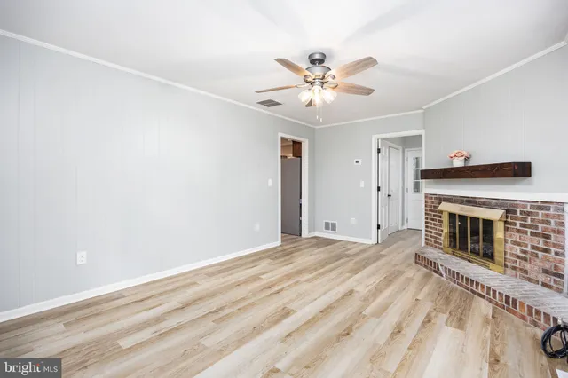 a view of empty room with fireplace