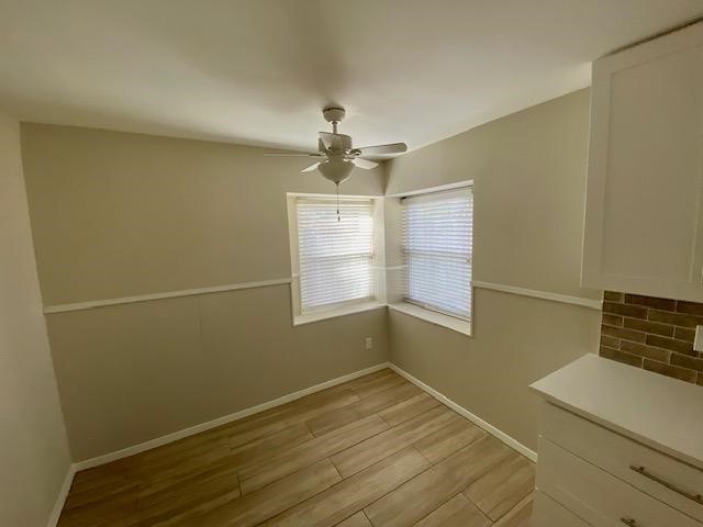 6002 Effingham Drive Houston, TX 77035 - Photo 11 of 22 a view of empty room with wooden floor and fan