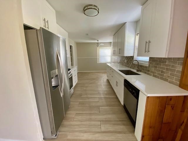 6002 Effingham Drive Houston, TX 77035 - Photo 7 of 22 a kitchen with sink a refrigerator and wooden floor