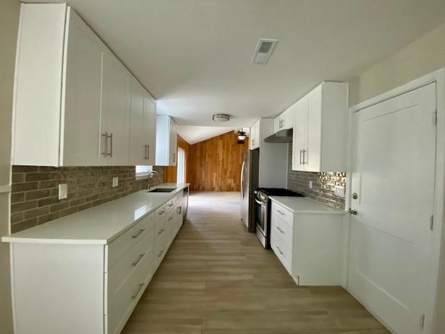 6002 Effingham Drive Houston, TX 77035 - Photo 8 of 22 a kitchen with a sink stove and cabinets