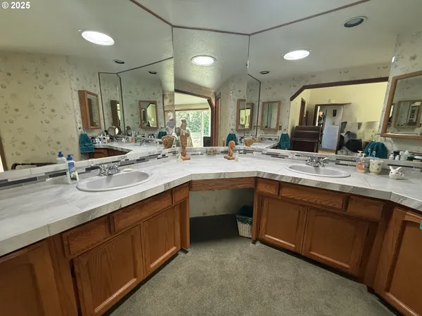 a bathroom with a sink double vanity granite and a mirror