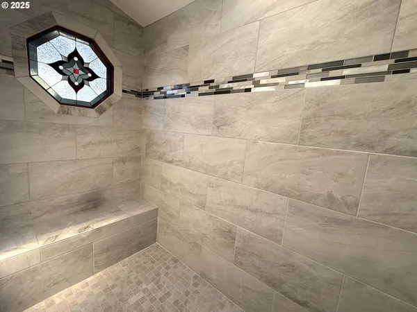a bathroom with a shower and a sink