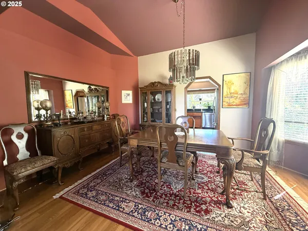 a living room with furniture wooden floor and a table