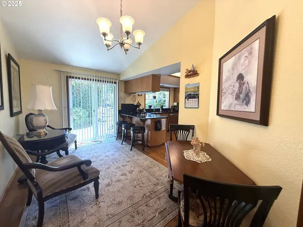 a living room with furniture a chandelier and a dining table