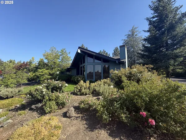 a view of a house with a yard and garden